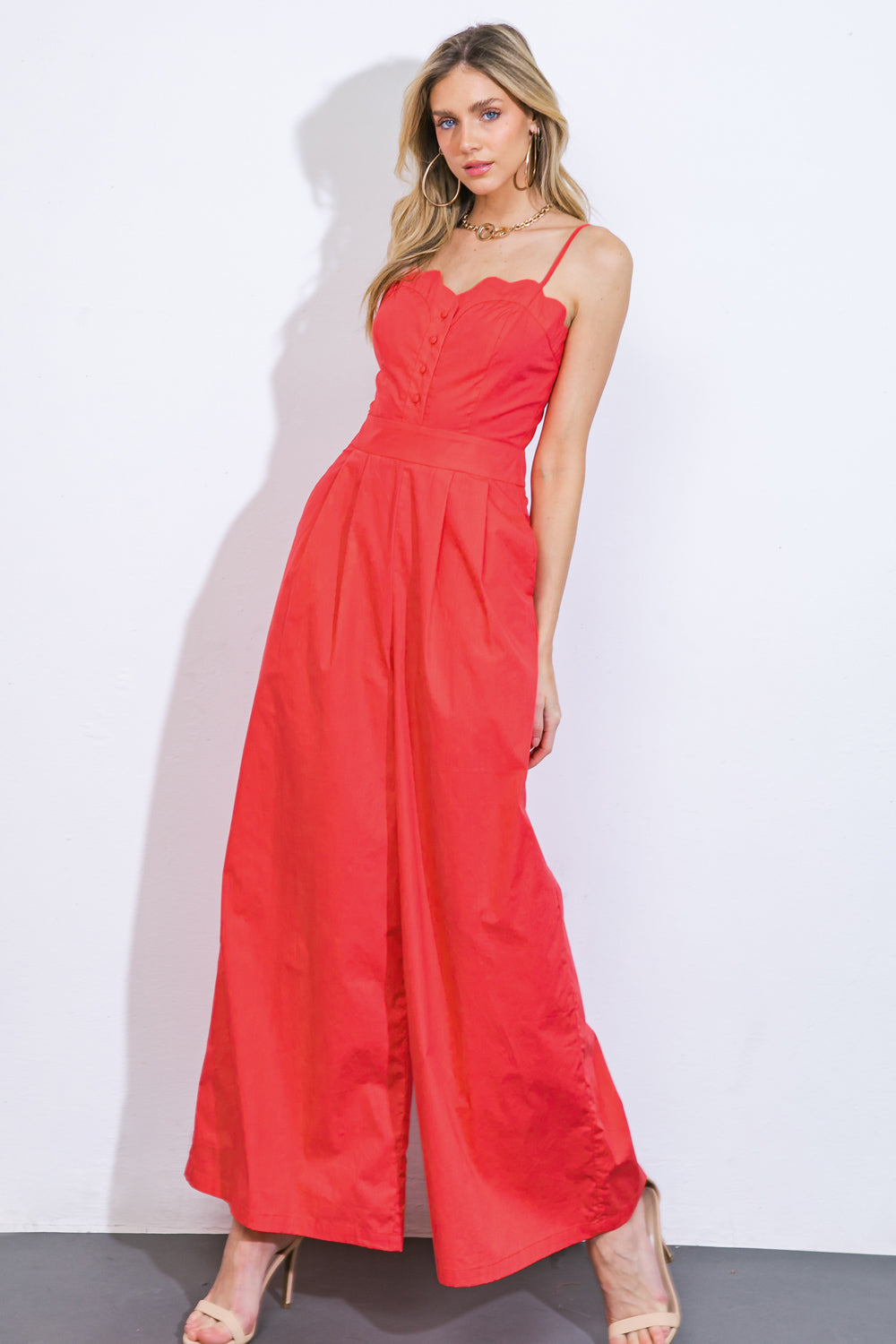 Coral jumpsuit styled as a comfortable travel outfit for women