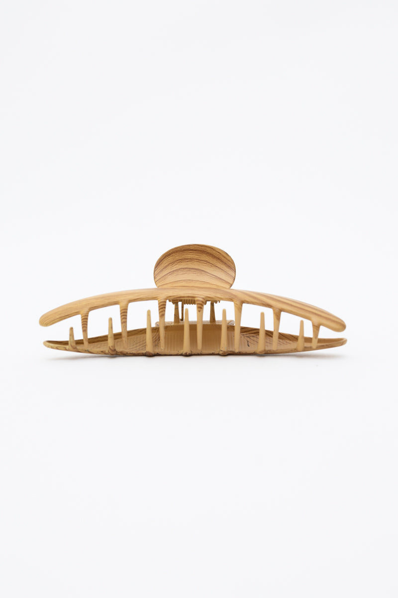 Rustic wood grain metal hair clip for secure hairstyles.