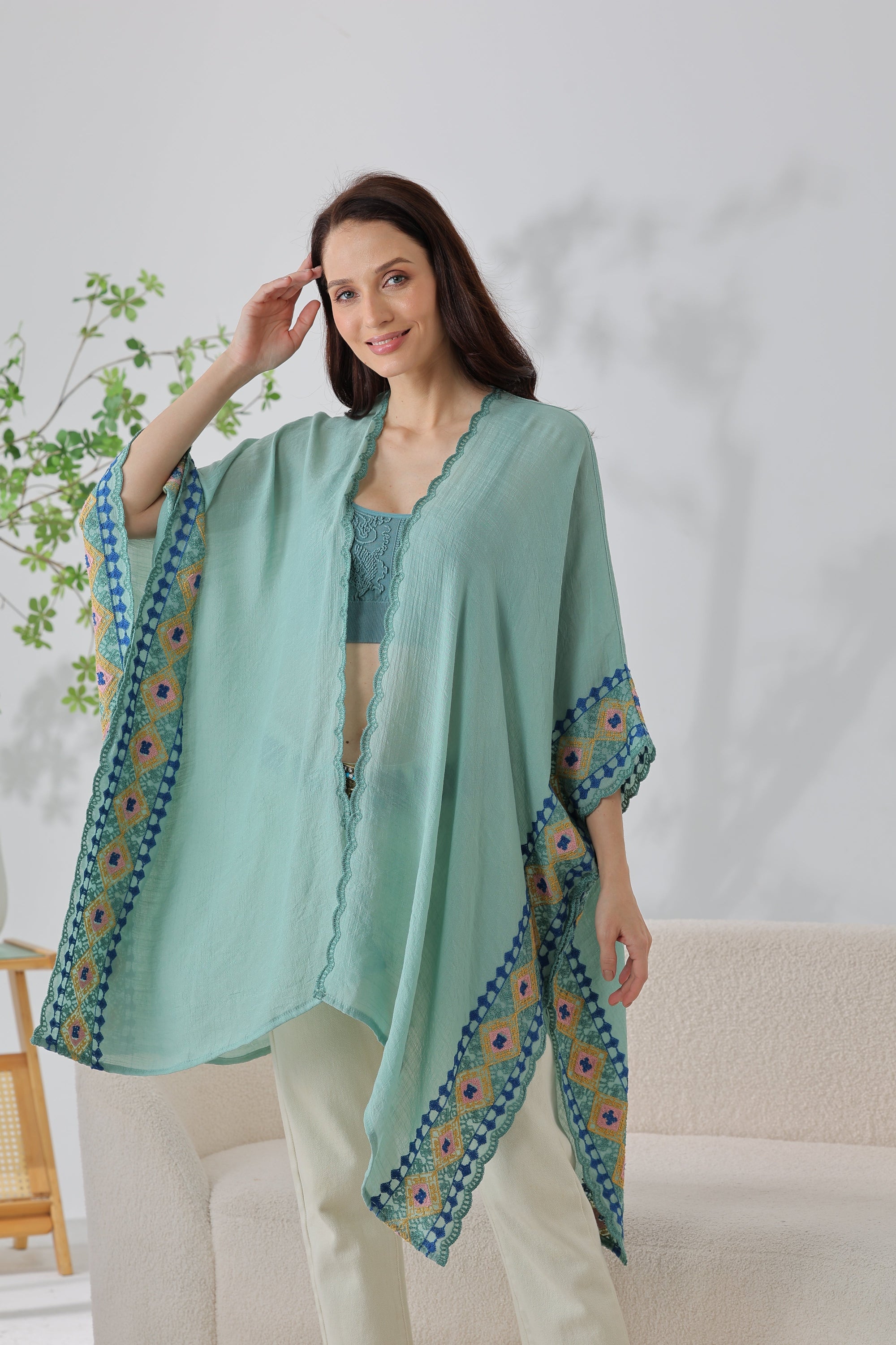 Sage bohemian embroidered trim kimono styled as a flowing boho layer