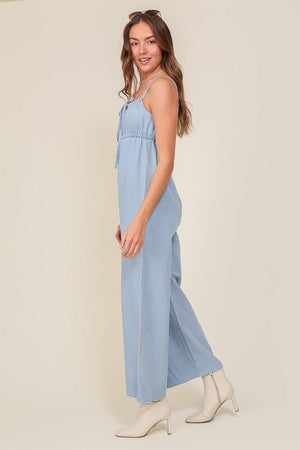 DENIM BLUE SLEEVELESS JUMPSUIT WITH SELF FRONT TIE Lumiere 