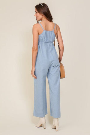 DENIM BLUE SLEEVELESS JUMPSUIT WITH SELF FRONT TIE Lumiere 