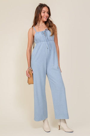 DENIM BLUE SLEEVELESS JUMPSUIT WITH SELF FRONT TIE Lumiere 
