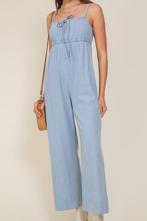 DENIM BLUE SLEEVELESS JUMPSUIT WITH SELF FRONT TIE Lumiere 